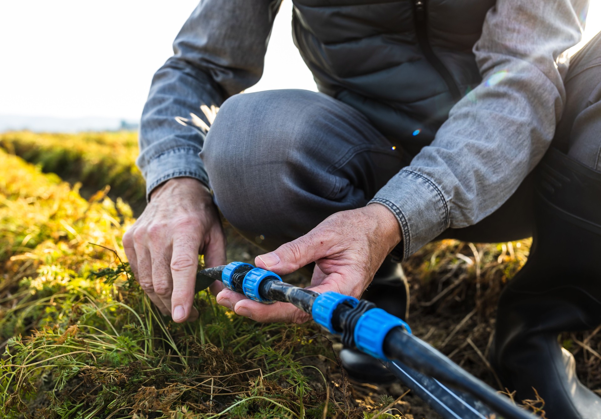 Farmer repairing irrigation system in field